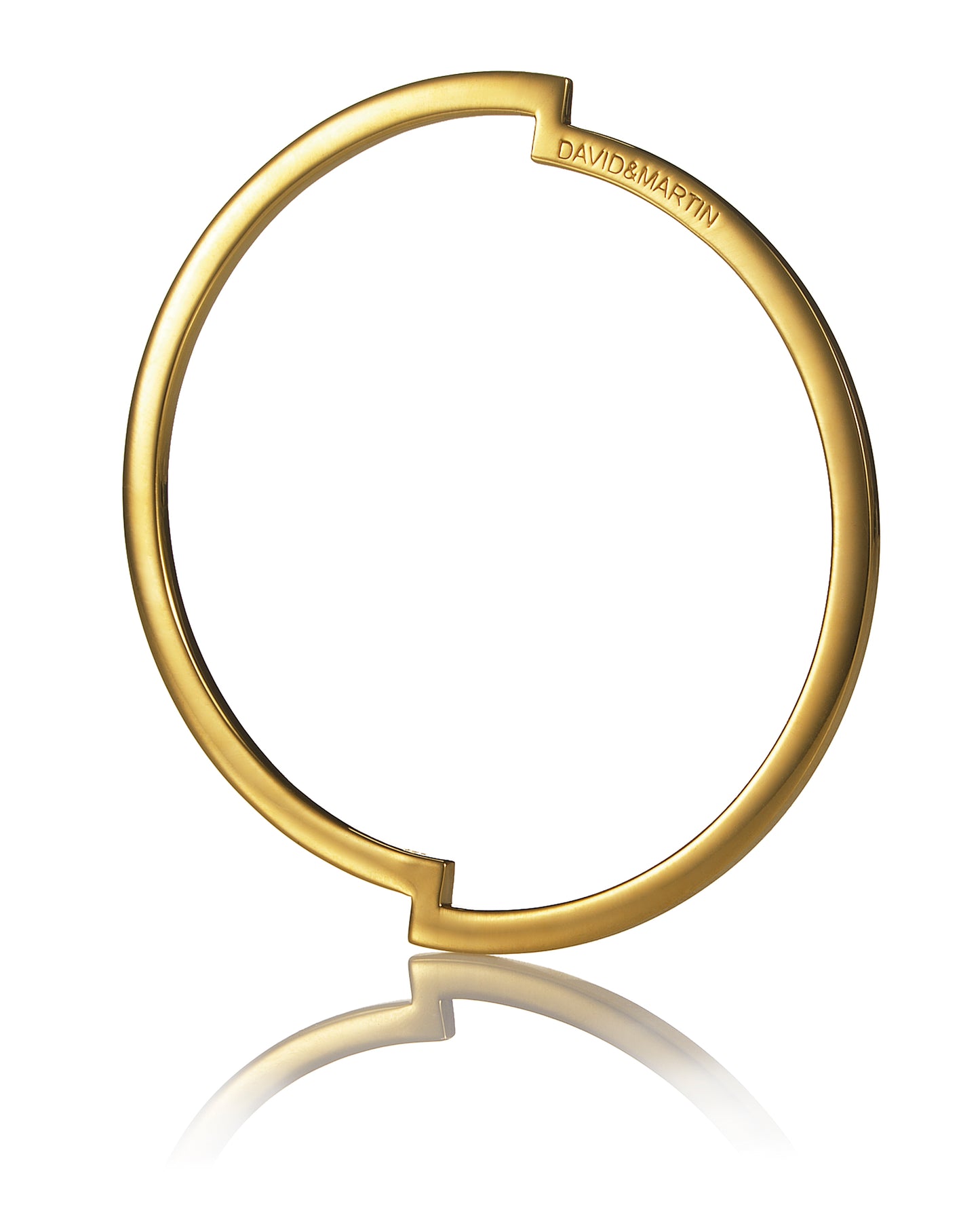 Minimalist bangle representing a deconstructed circle from Drift collection. Material: 18 karat gold-plated silver.