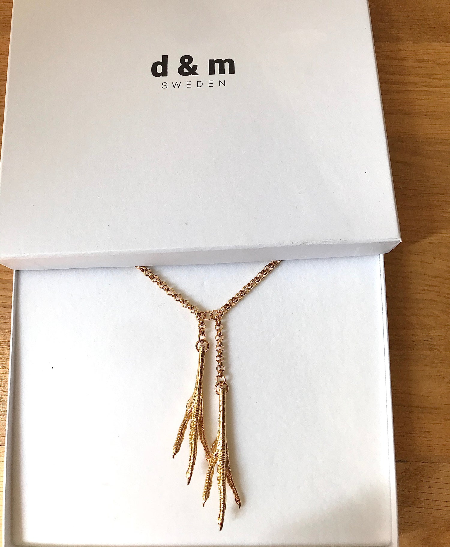 Iconic 18karat gold plated Chicken Feet necklace from David&Martin Jewellery. The collection was inspired by a beautiful girl spotted by the designers in Shanghai underground. The girl was munching fried chicken feet and simultaneously flicking through French Vogue