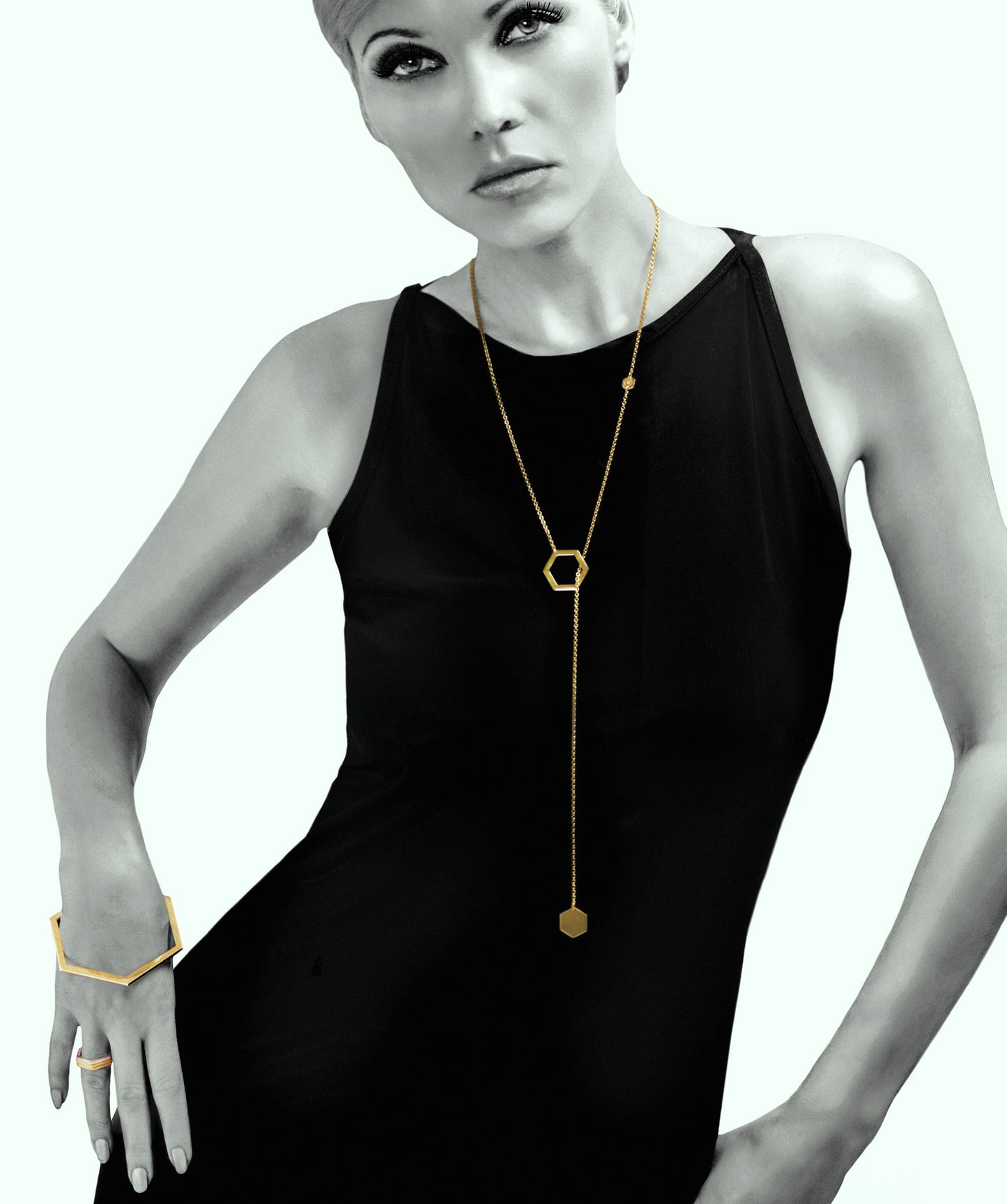 18 karat gold plated 925 silver slip-through necklace with hexagon-shaped pendant. The chain can be wrapped around the neck twice, turning this long necklace into a choker. Original design from iconic Cell collection by David&Martin. Total length 90cm.