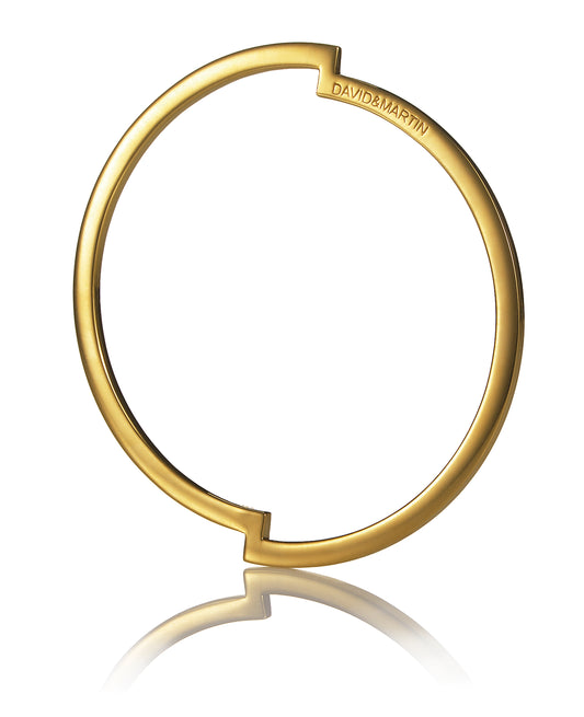 Minimalist bangle representing a deconstructed circle from Drift collection.  Material: 18 karat gold-plated silver.